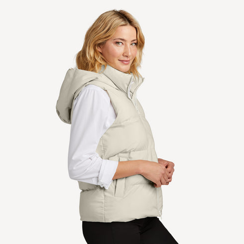 Side view of women’s navy and cream waterproof puffer vest on model – Louvóre apparel